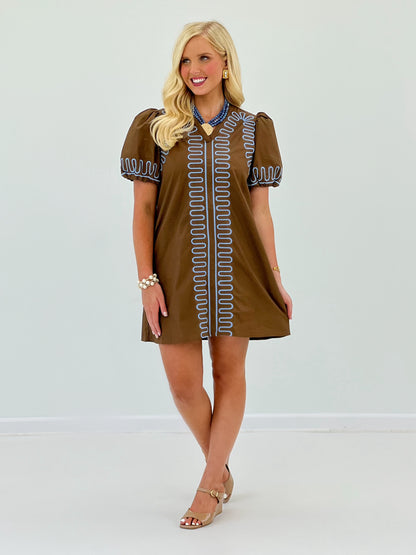 Brown short-sleeve dress with blue embroidered trim and scalloped border, above-knee
