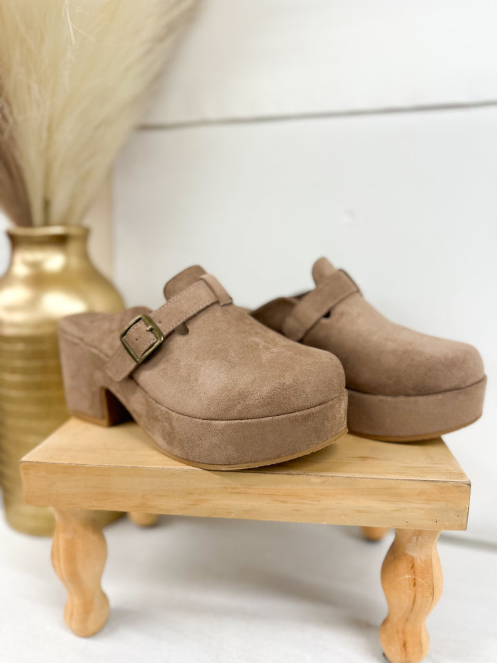 Taupe suede clog mules with buckled strap and low block heel, side view