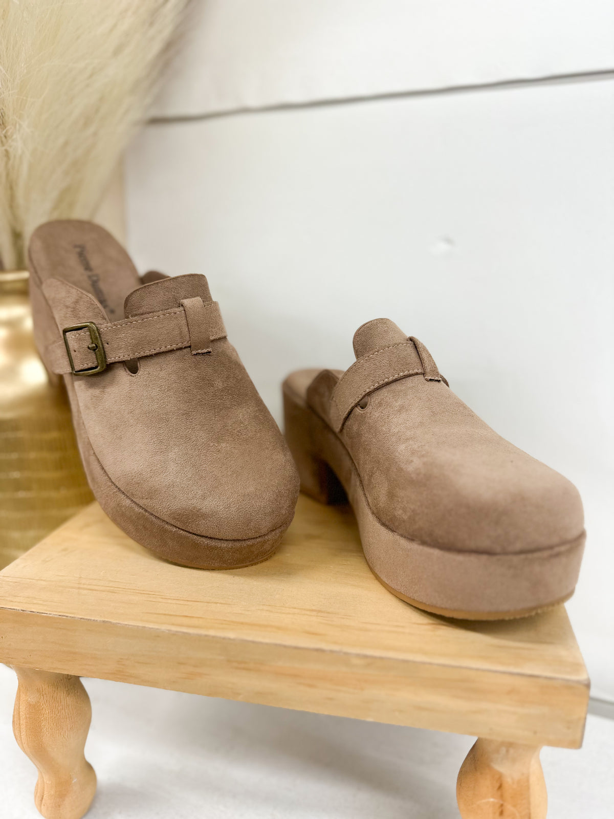 Pair of taupe suede mule clogs with adjustable buckle strap and block heel