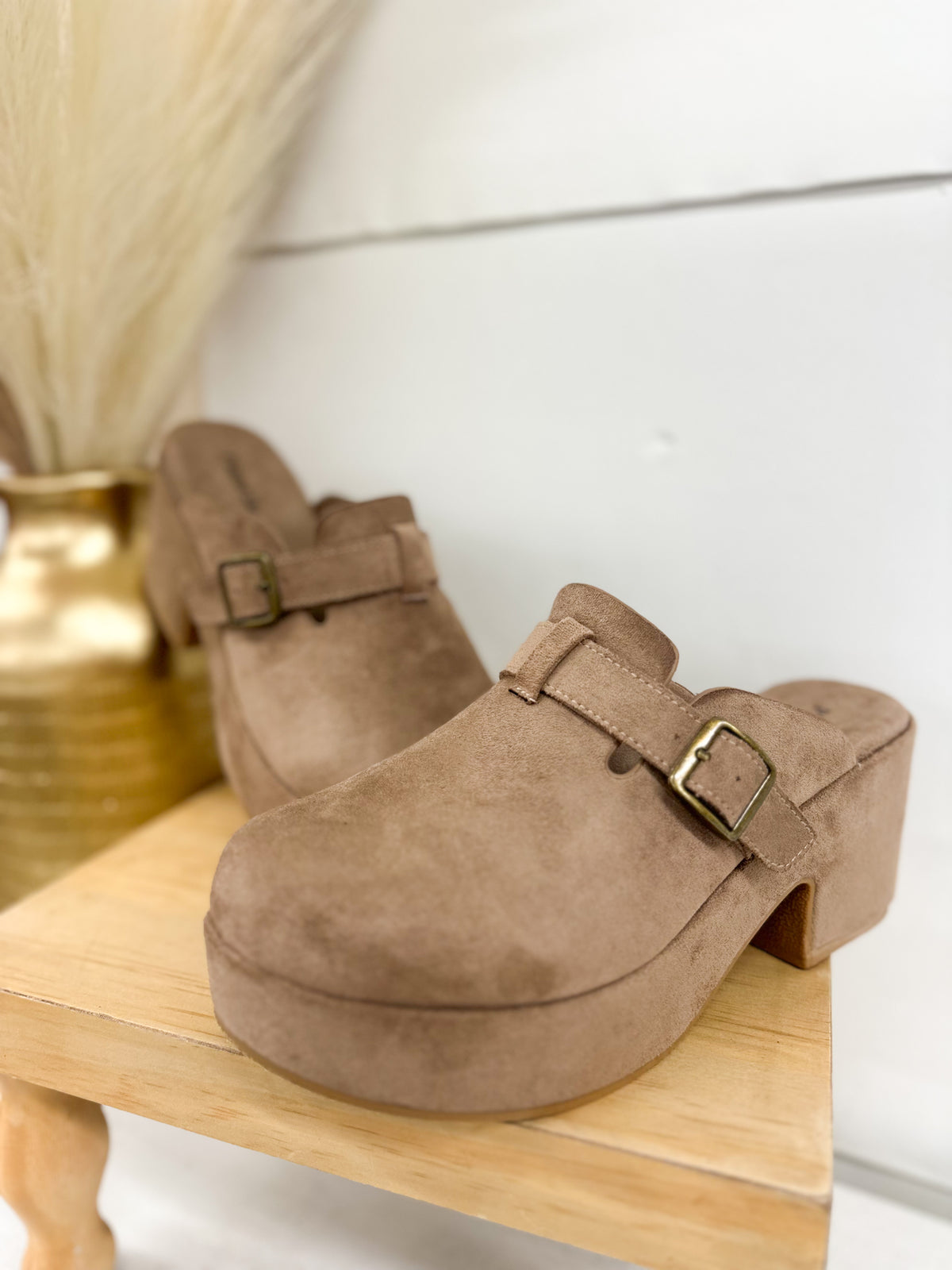 Taupe suede clog with buckled strap and chunky block heel, slip-on design