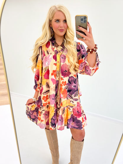 Floral smocked yoke button-front mini dress, long sleeves, ecru base with pink purple blooms