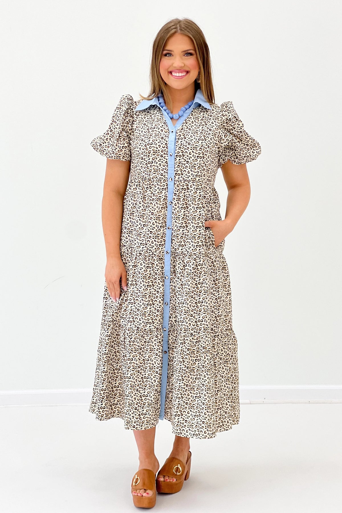 Animal-print puff sleeve dress with blue trim, button front, and midi skirt