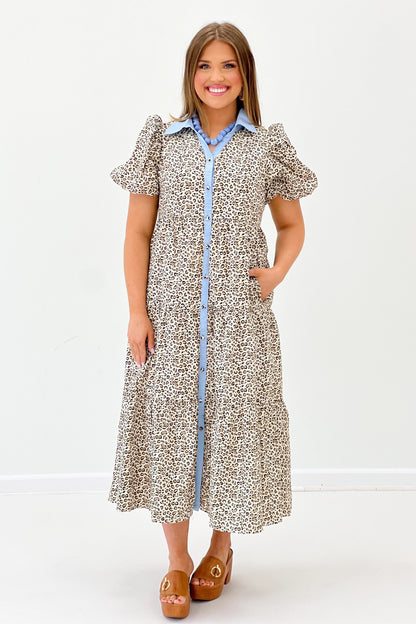 Animal-print puff sleeve dress with blue trim, button front, and midi skirt