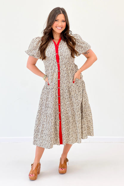 Animal-print puff sleeve dress with red trim, button front, and midi skirt