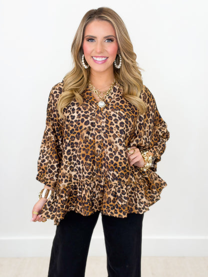 Leopard print button peplum top with ruffled cuffs and short flared hem