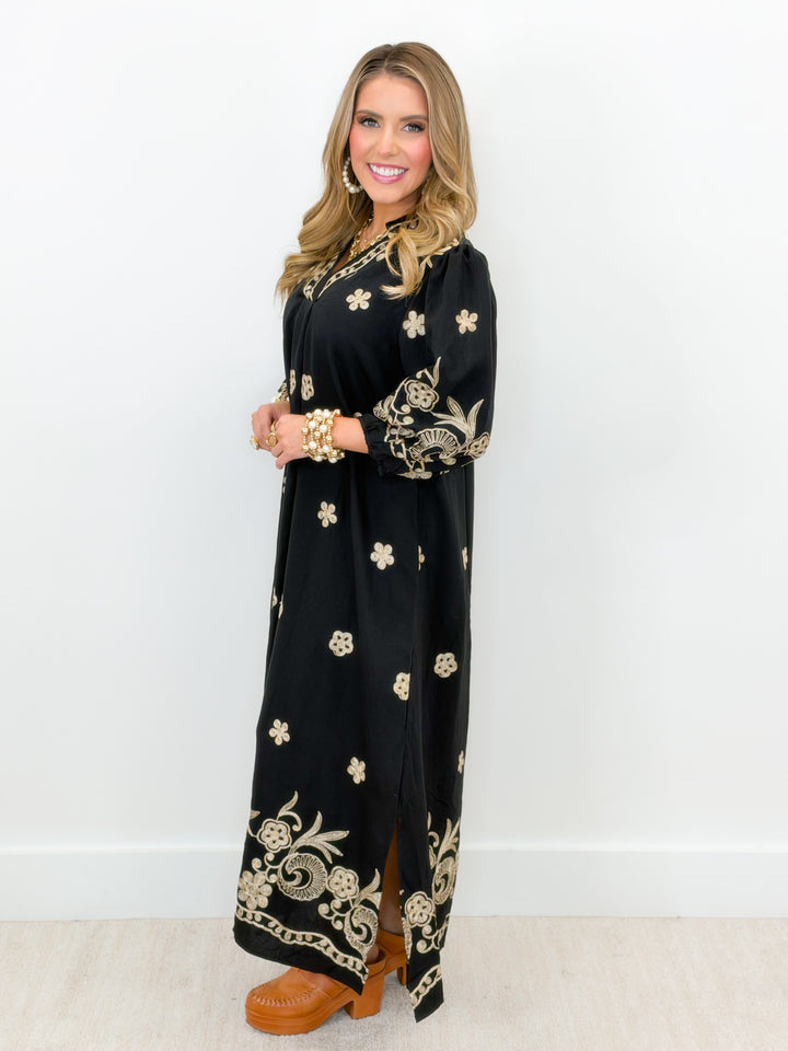 Black long-sleeve embroidered midi dress with wide open collar and gold floral pattern