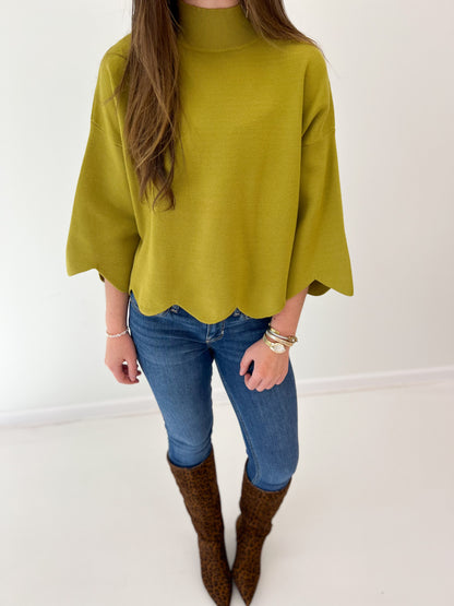 Bright green mock neck sweater top with scalloped hem detail and loose fit