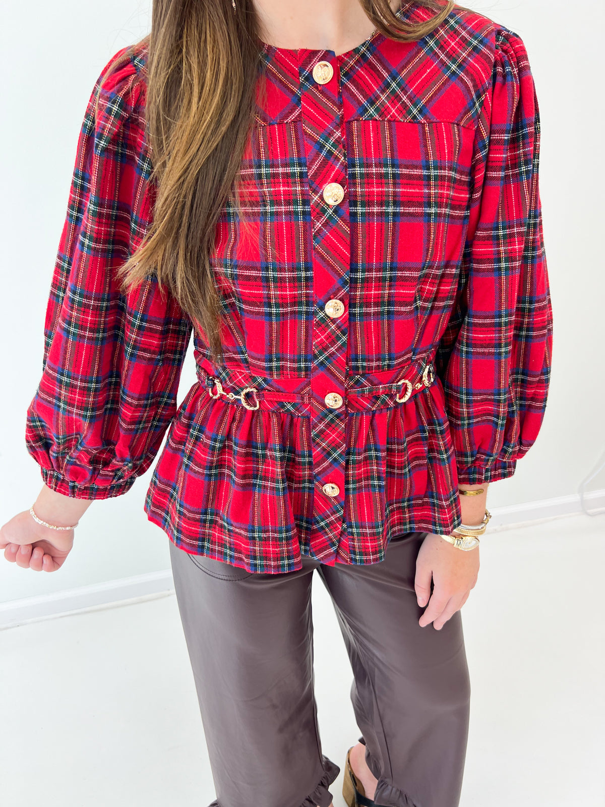 Red plaid peplum top close-up: button front and cinched waist belt with loops