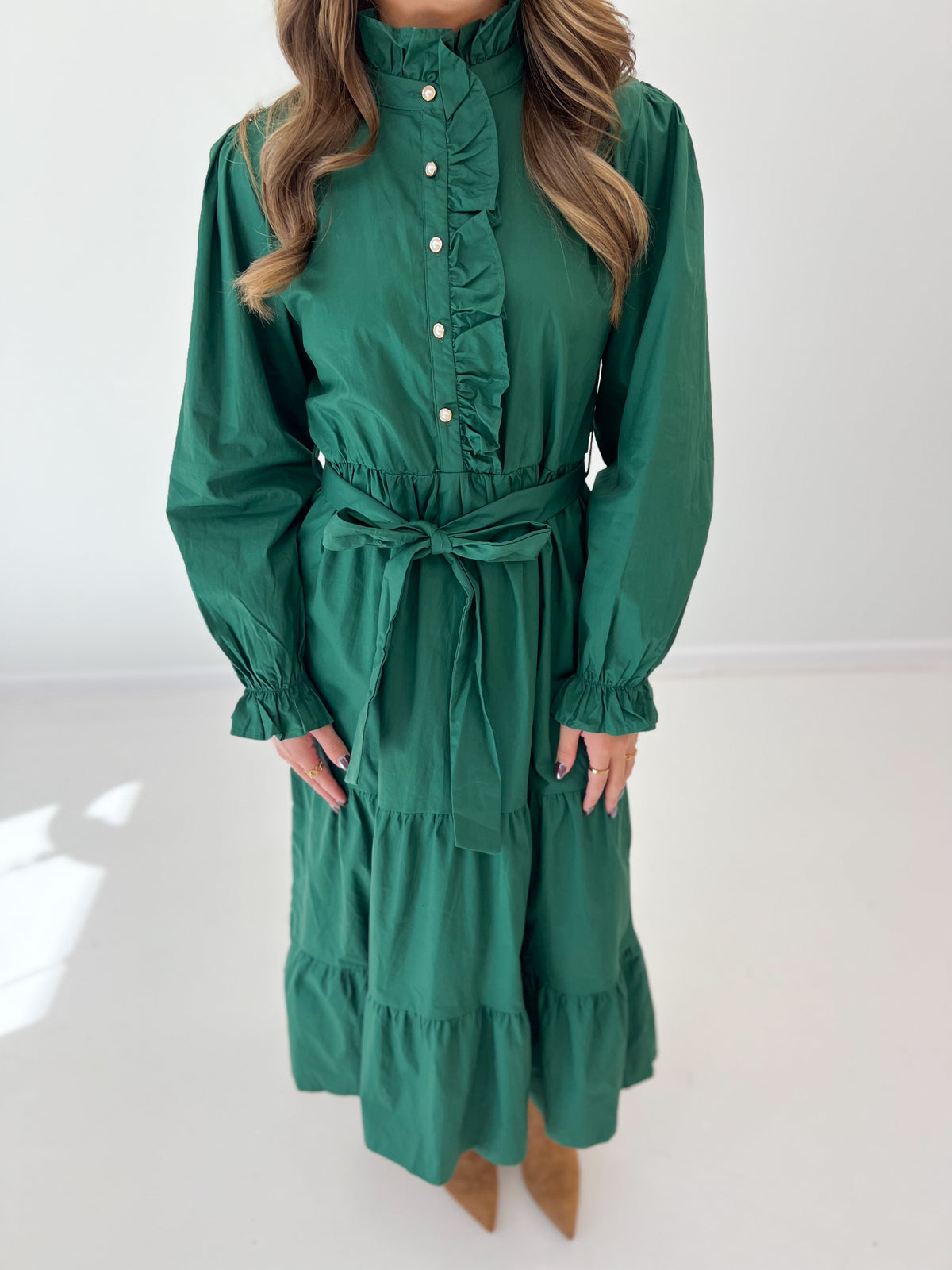 Hunter green tiered midi dress with ruffle front, button placket, tied waist