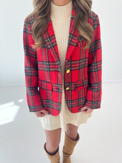 Red and green tartan check blazer close-up with gold buttons and flap pockets