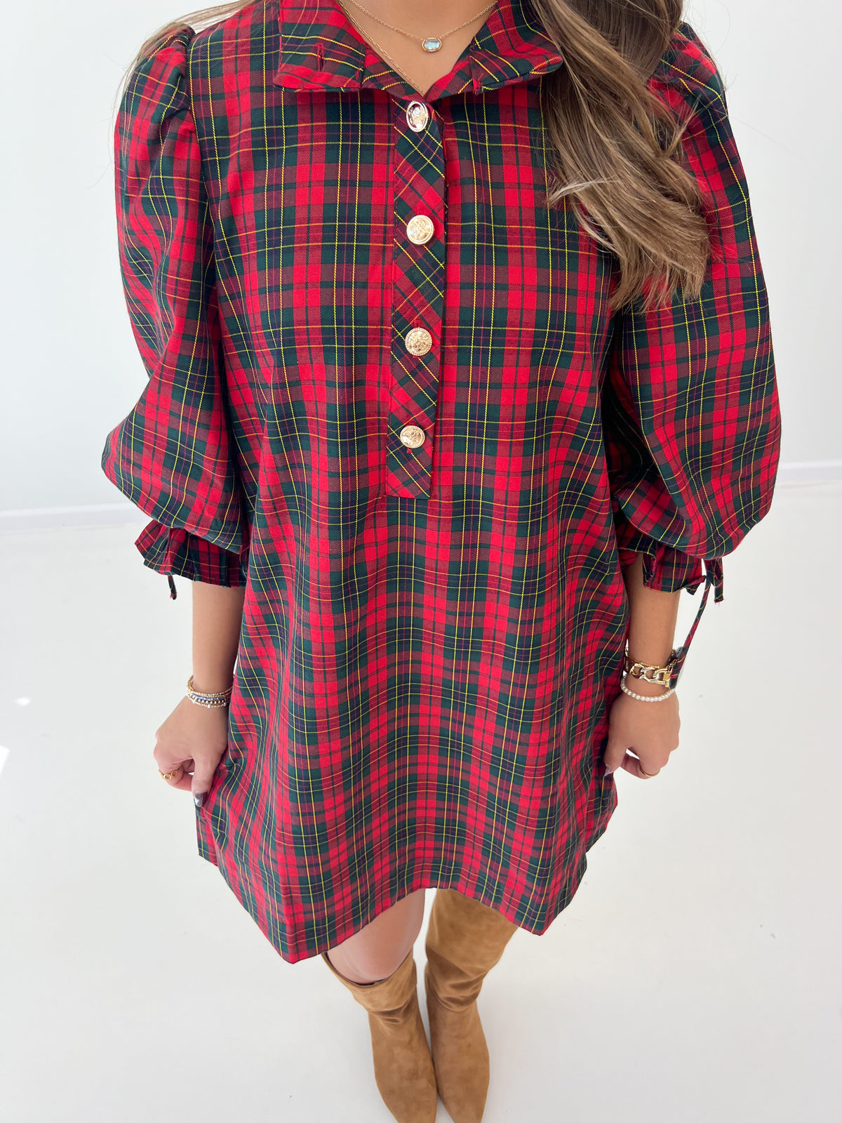 Red plaid mini dress close-up: button placket, collar, balloon sleeves with ties.