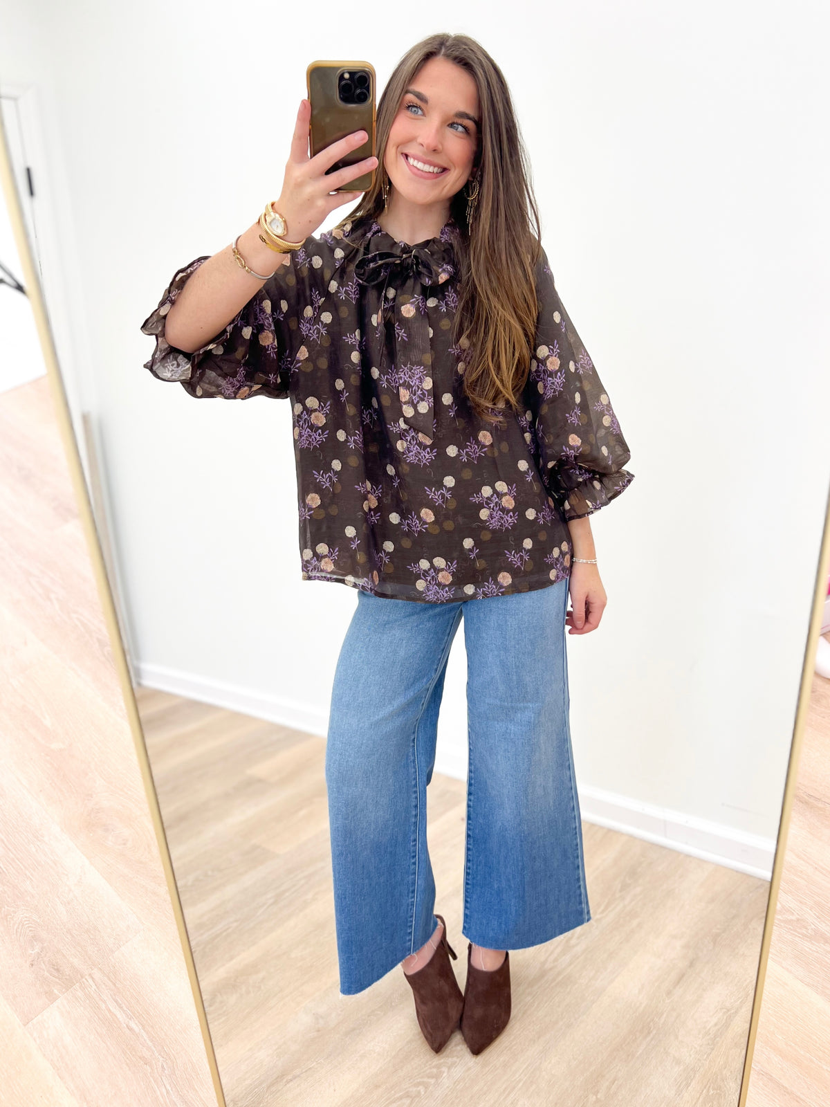 Brown floral poncho-sleeve V-neck top with ruffled neckline and sheer sleeves