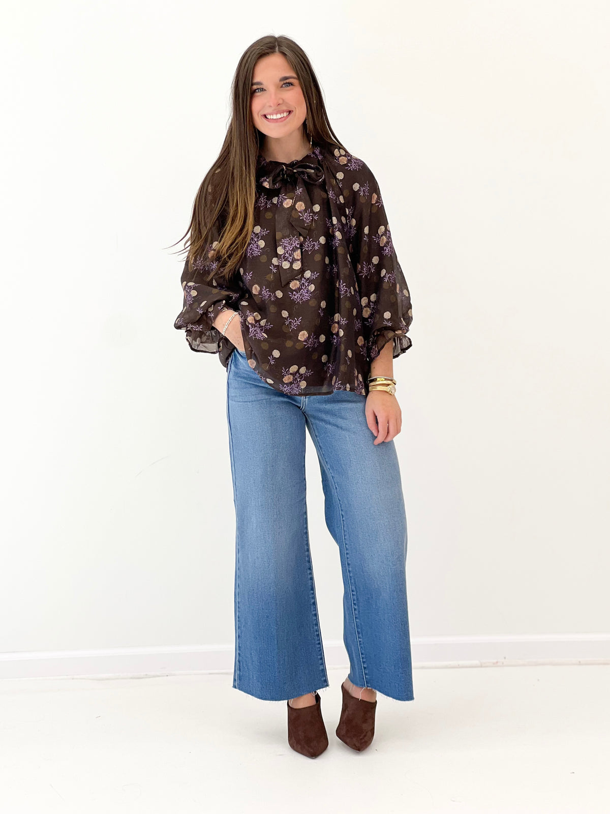 Brown floral poncho-sleeve V-neck top with gathered cuffs and ruffled collar