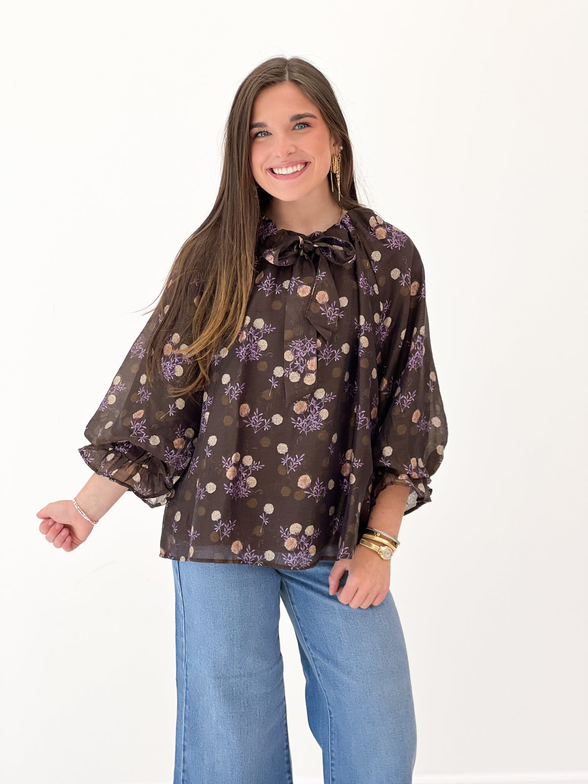 Brown floral poncho-sleeve V-neck top with bow tie ruffle collar