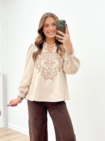 Stone long-sleeve top with faux suede look and ornate embroidered applique front