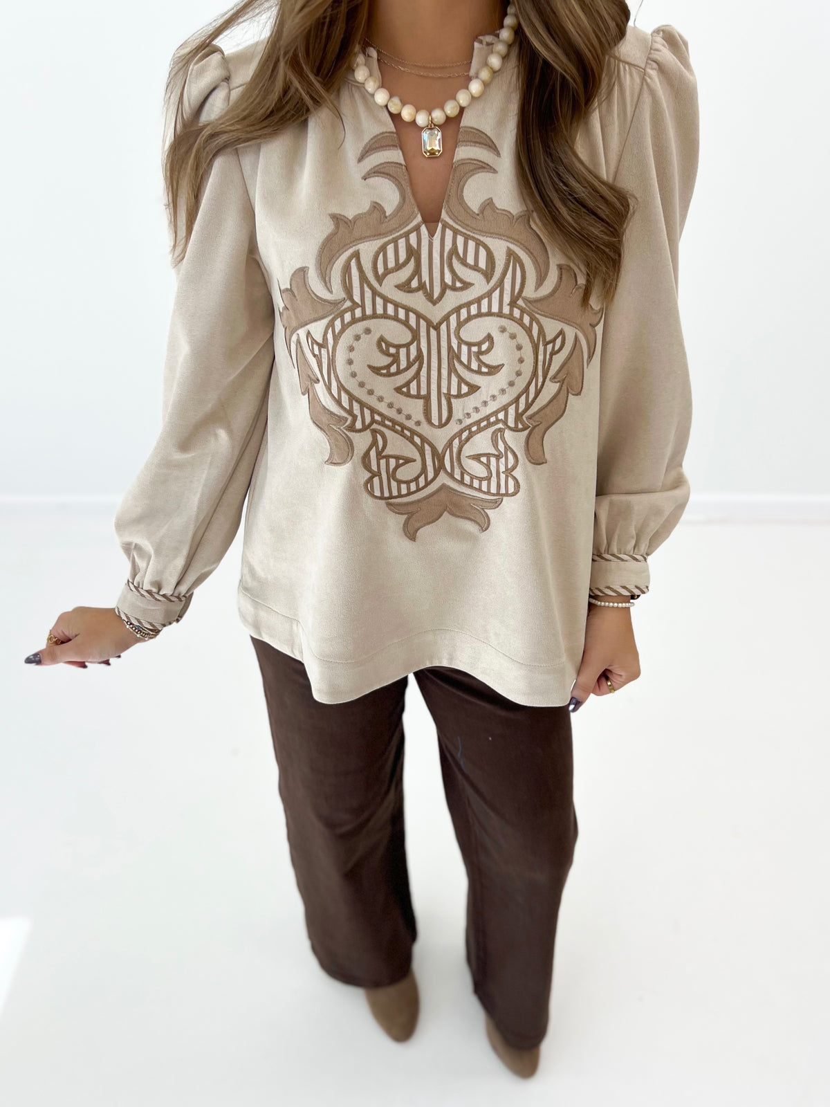 Stone long-sleeve top with large center embroidered applique and puff sleeves