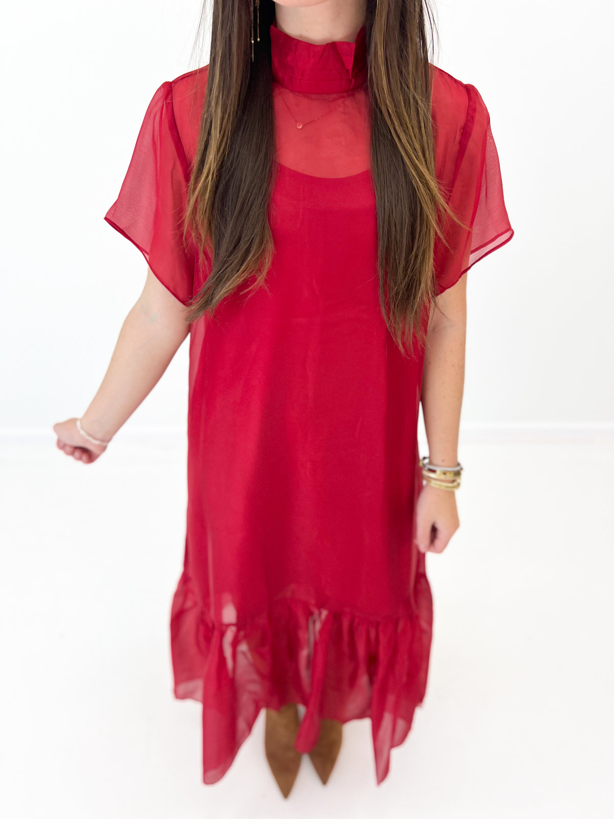 Red chiffon midi dress detail view: high neck sheer sleeves and tiered ruffle hem