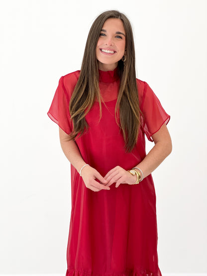 Red chiffon midi dress with high neckline, short sleeves, and flowing tiered skirt