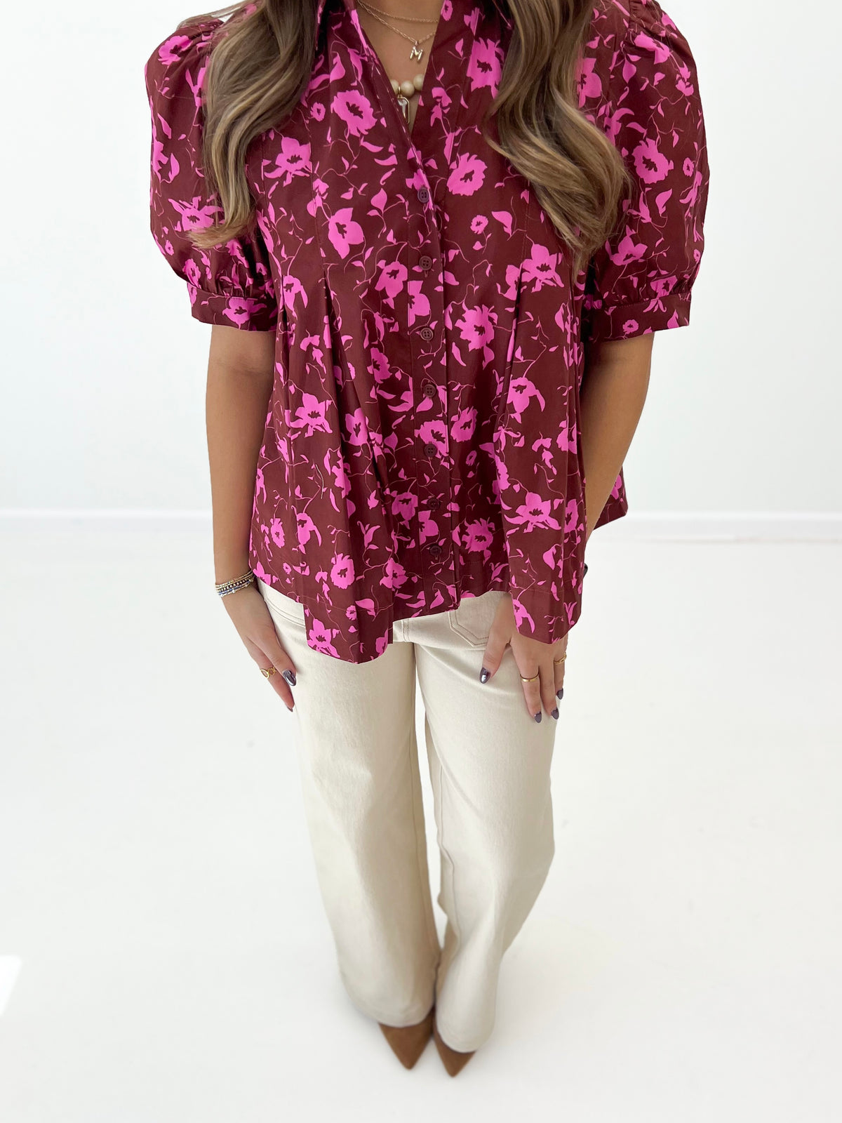 Burgundy floral puff-sleeve blouse front with button placket and gathered shoulders.