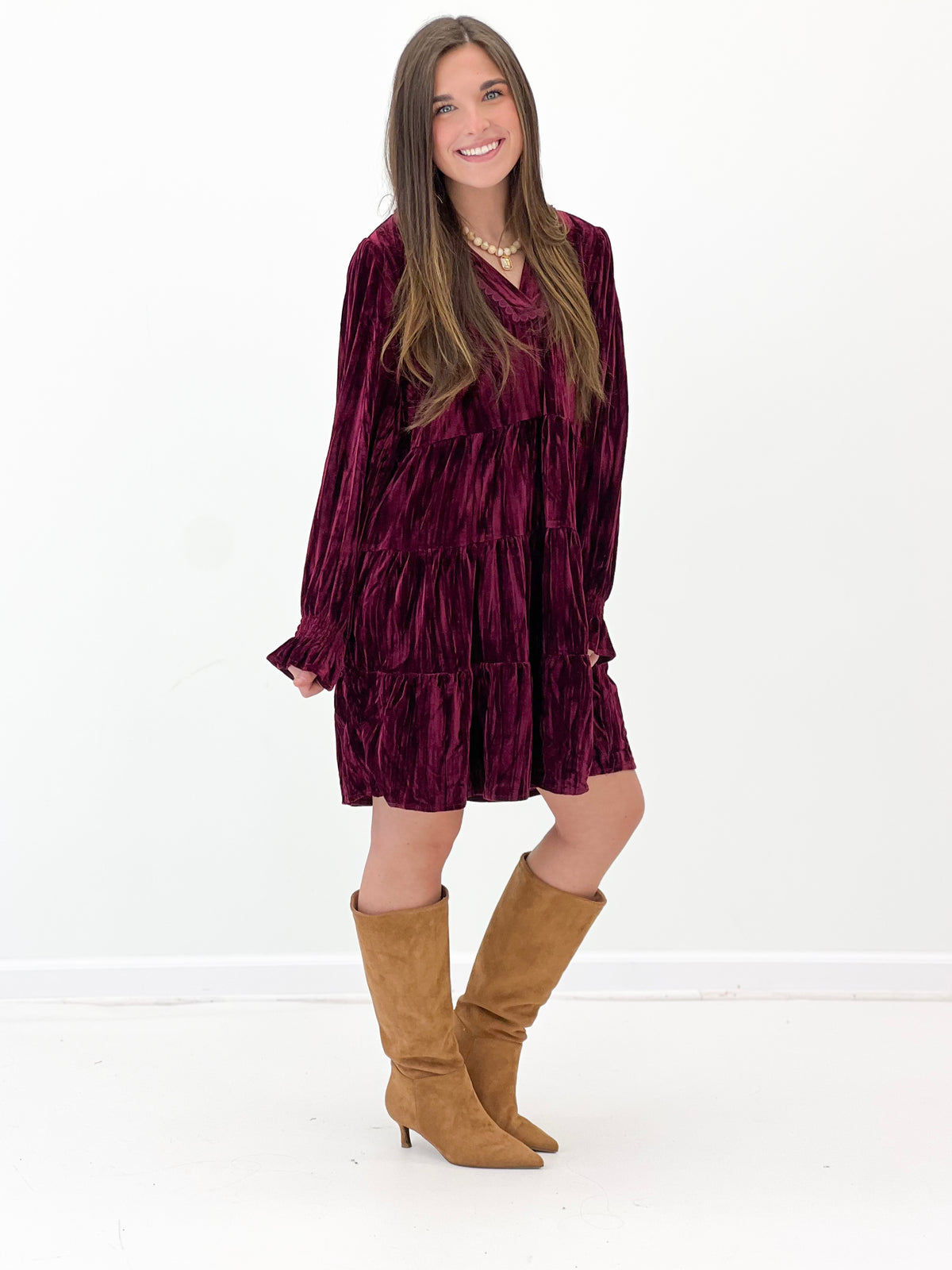 Burgundy velvet tiered long-sleeve mini dress with V-neck and tiered skirt