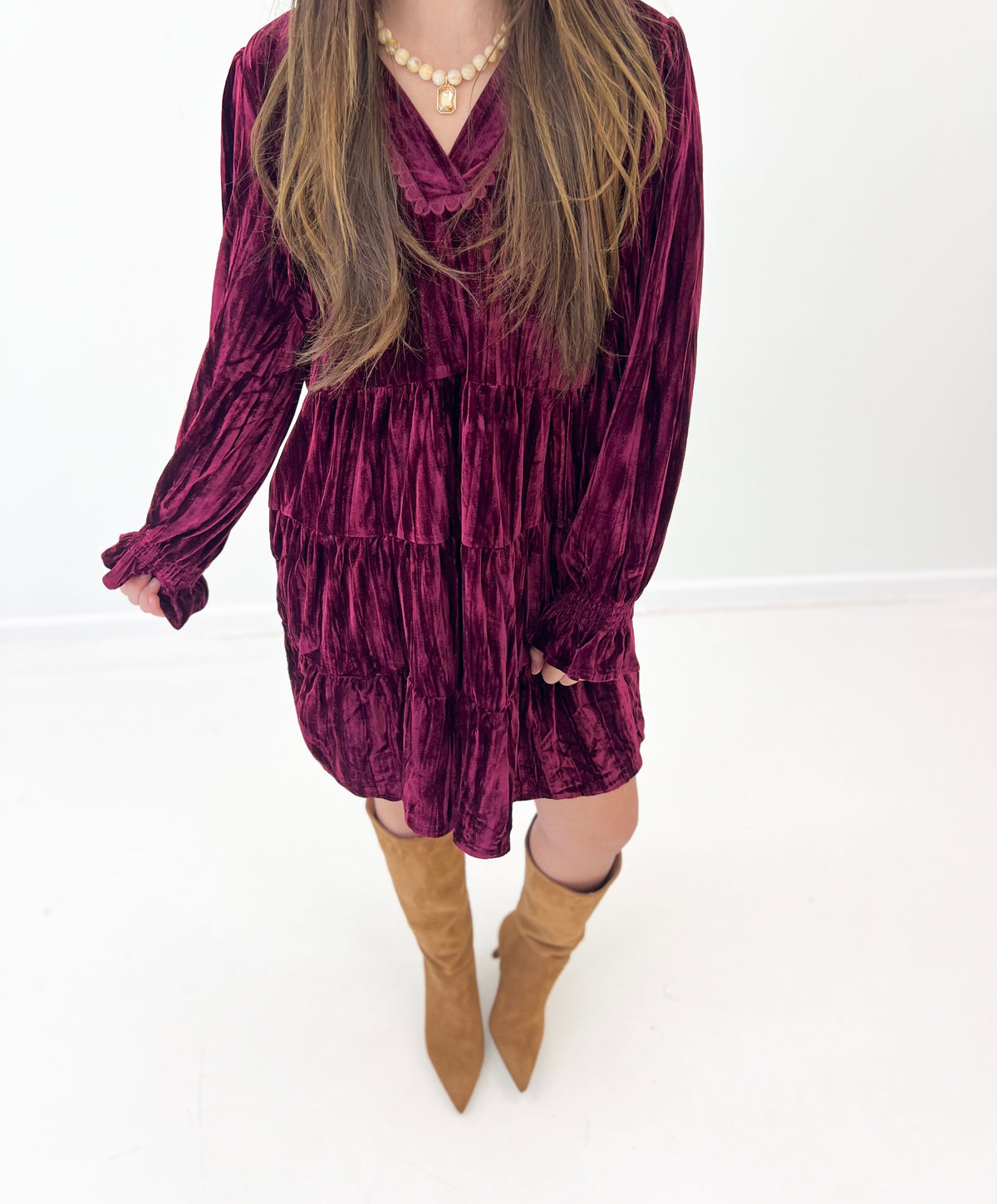 Burgundy velvet tiered mini dress with V-neck bodice and long sleeves
