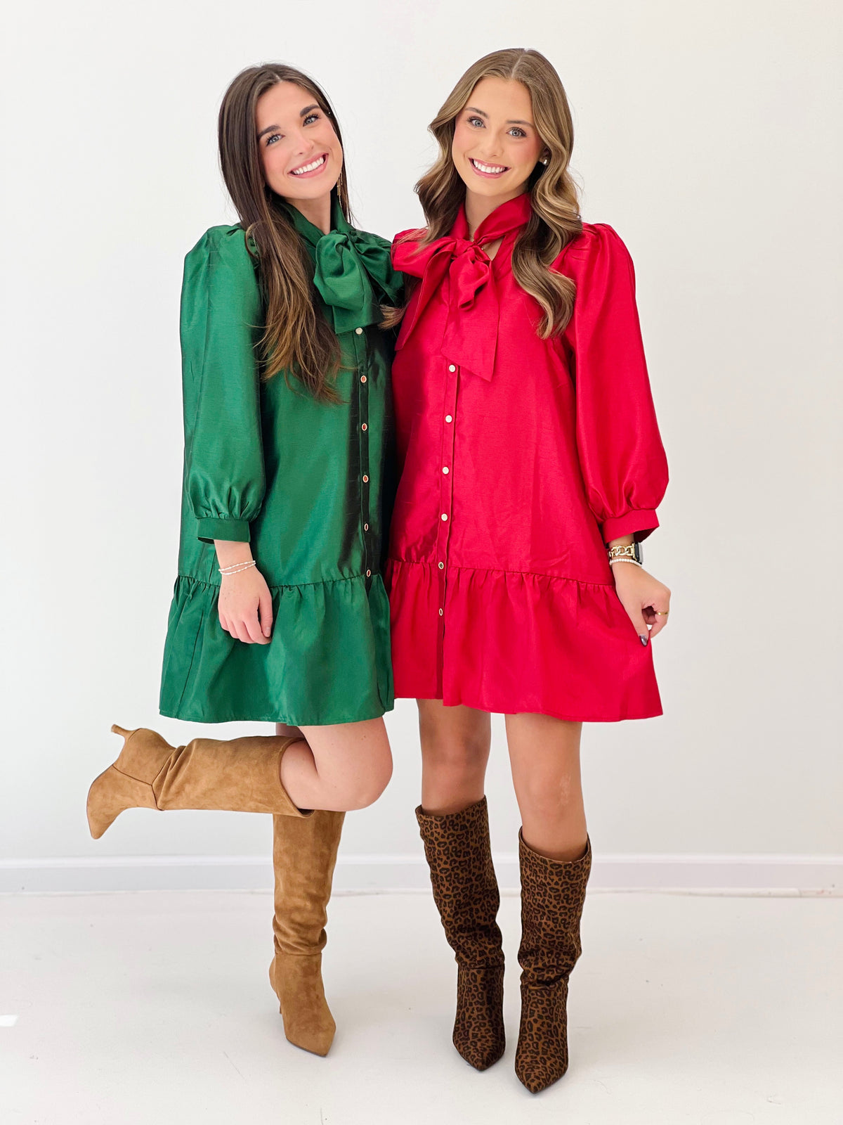 Pair of bow-neck mini dresses, green and red, button front with puff sleeves