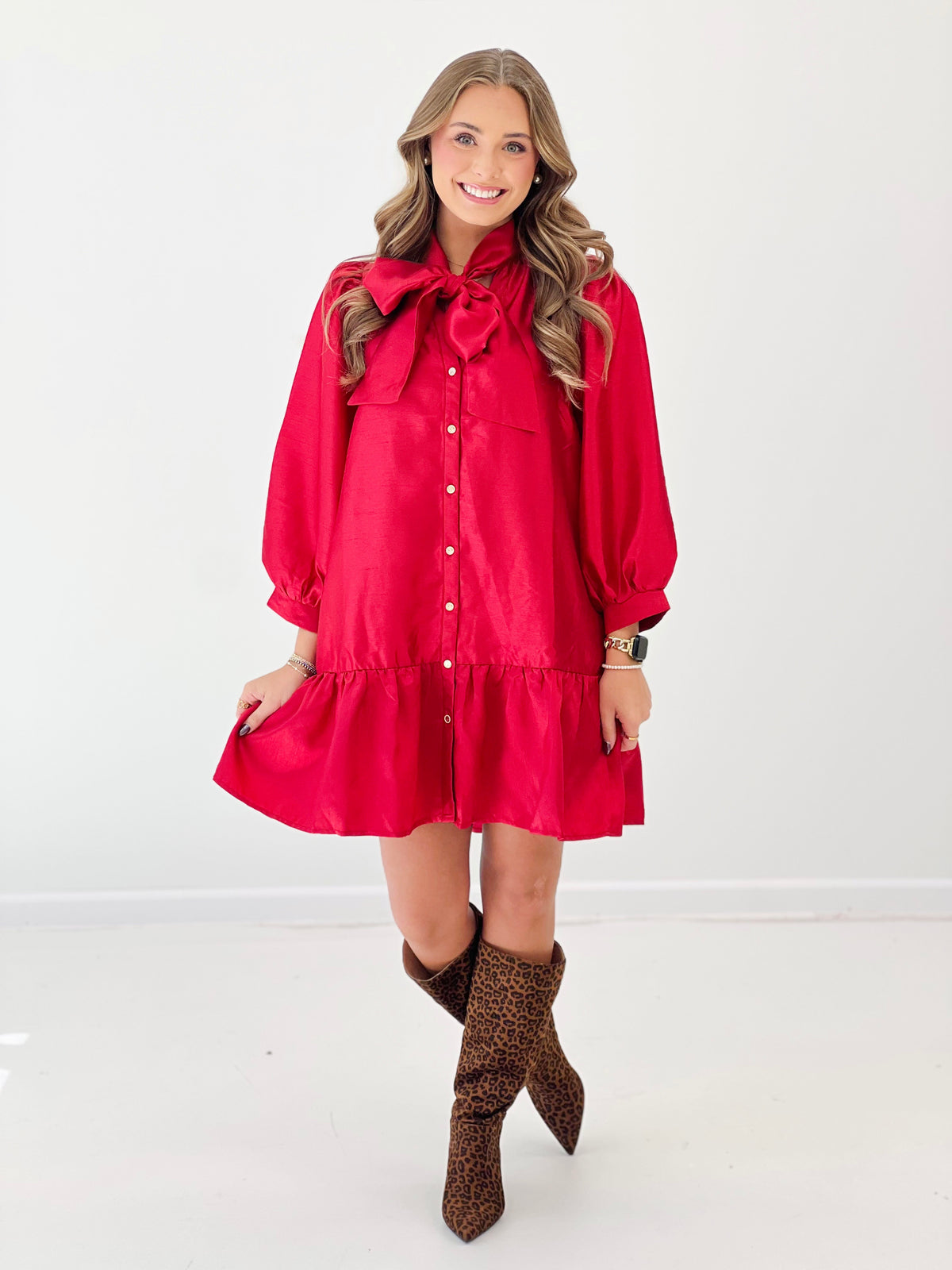 Red button-front mini dress with bow neckline and puff sleeves, ruffled hem