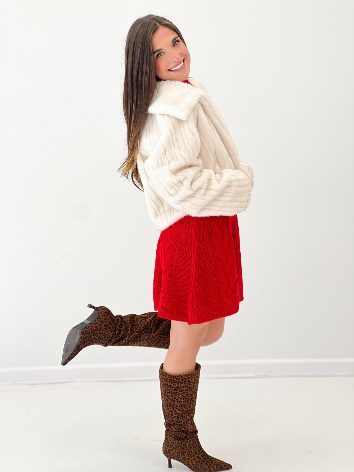 Cream faux fur crop jacket, full sleeves and open front, side profile