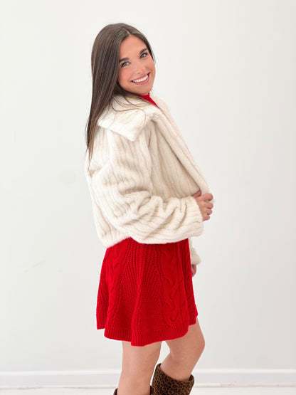 Cream faux fur crop jacket with fluffy collar, open front and ribbed cuffs