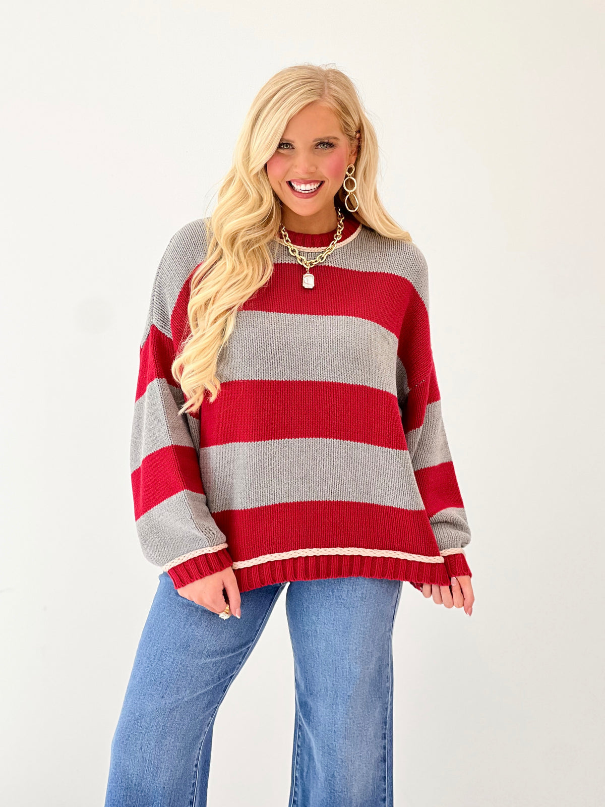 Oversized striped crew neck sweater in red and gray with ribbed hem and cuffs
