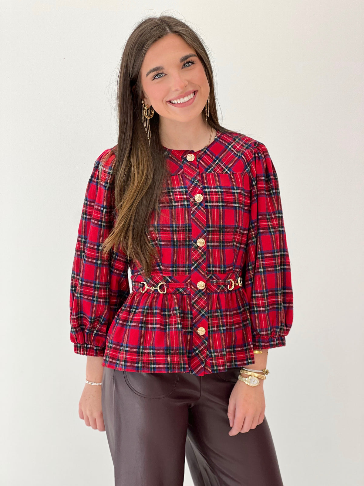 Red plaid peplum top with puff sleeves, front buttons, and waist belt detail