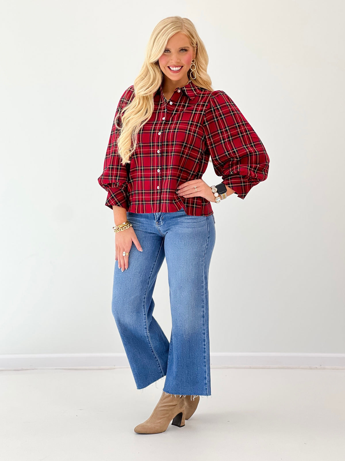 Red plaid stretch knit top with button placket, collar, and puffed sleeves with cuffs