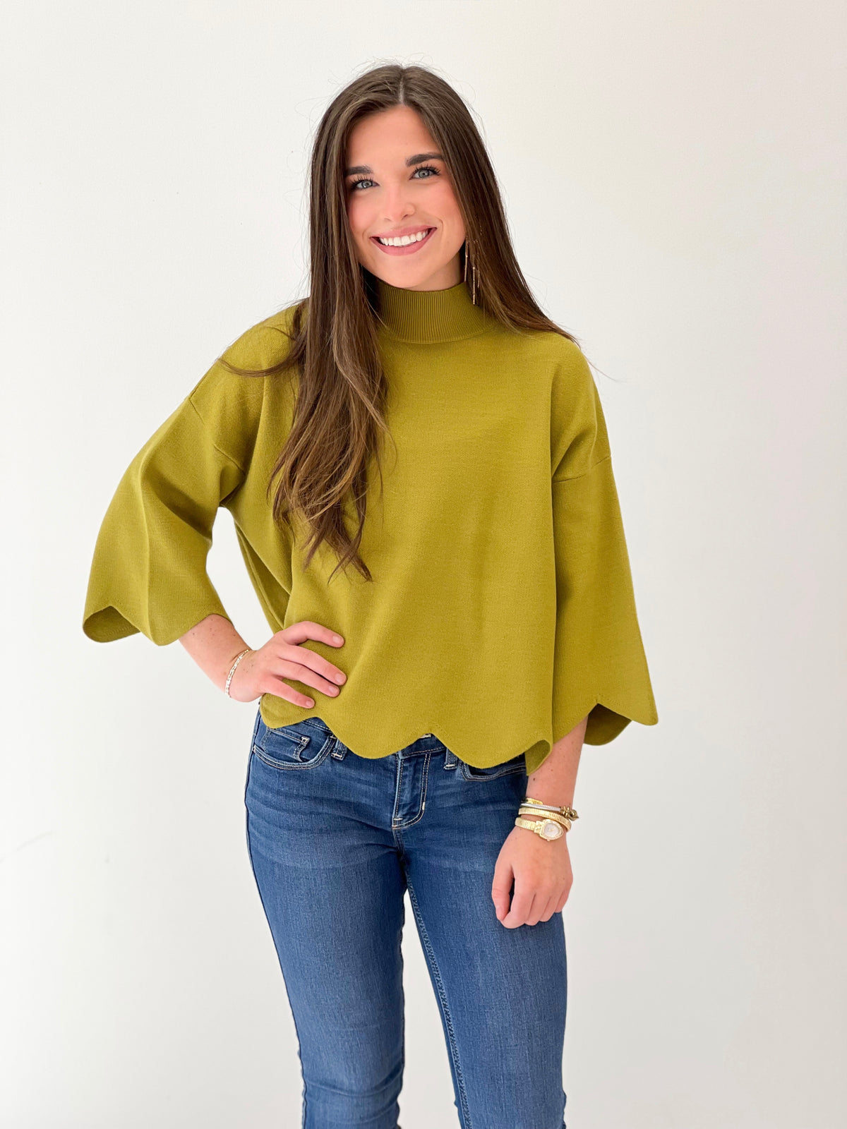 Bright green mock neck scalloped hem sweater top with relaxed, drapey fit