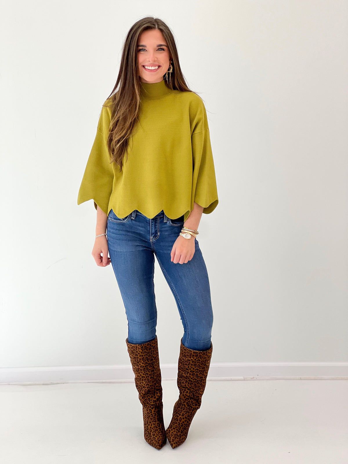 Bright green mock neck sweater with scalloped hem and loose dolman sleeves