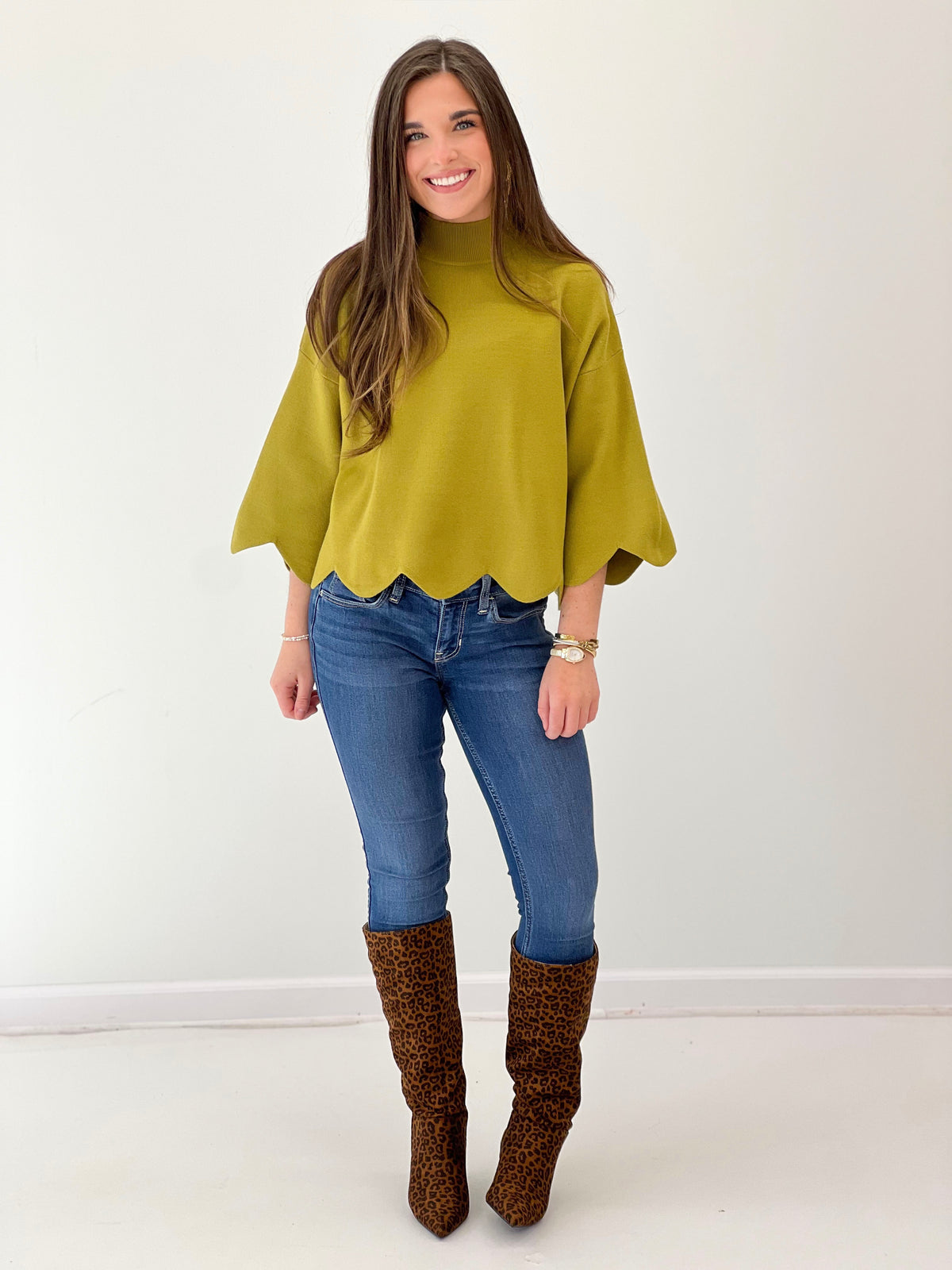 Bright green mock neck sweater top with scalloped hem and wide elbow-length sleeves