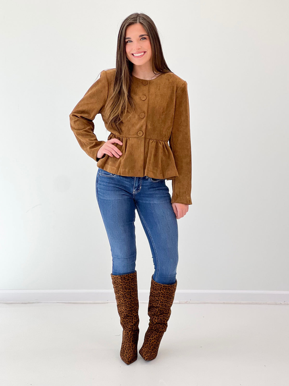Camel peplum hem jacket with button front and long sleeves, round neckline