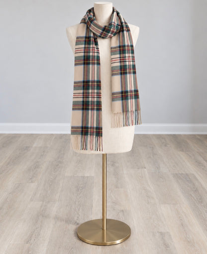 Tan plaid scarf with multicolor stripes and fringed ends, draped around a mannequin