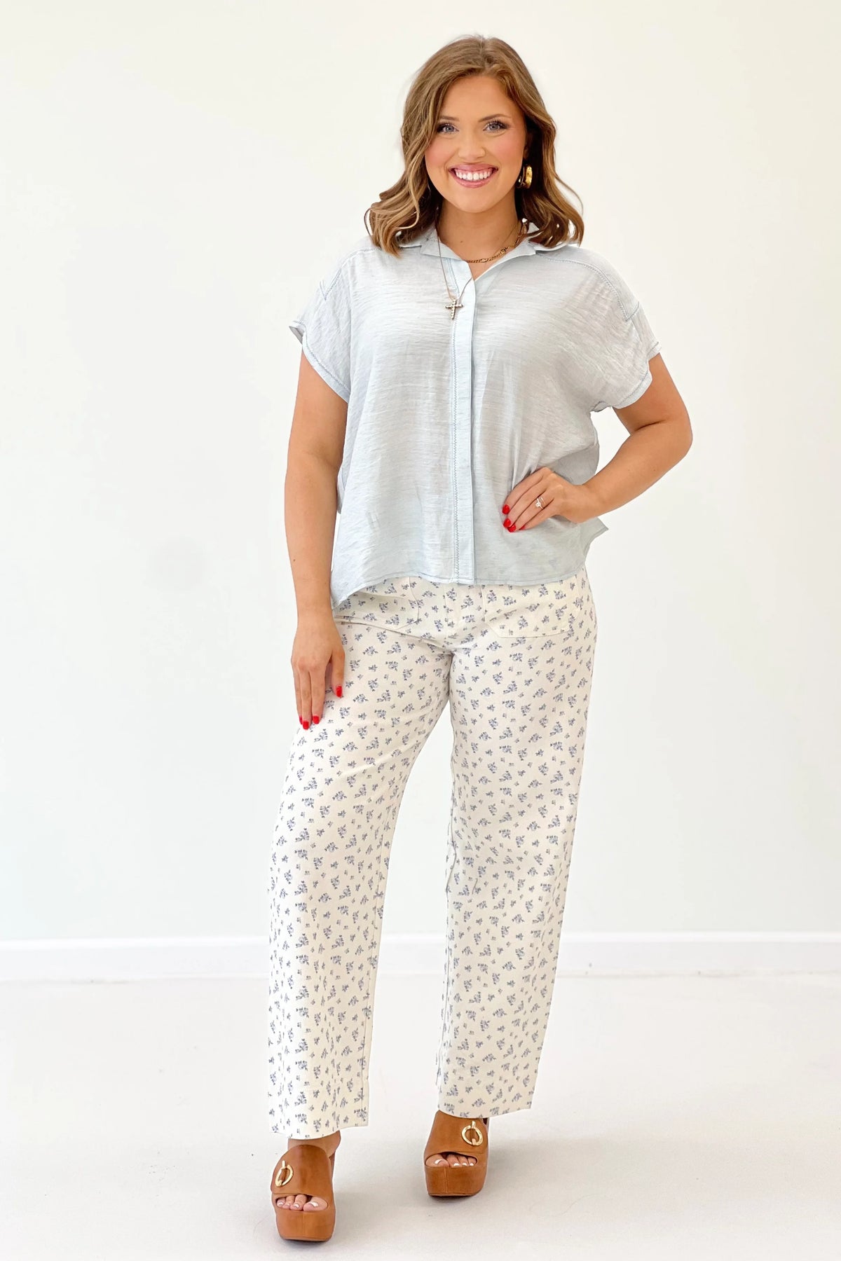 Light blue short-sleeve button-down collared top with front placket