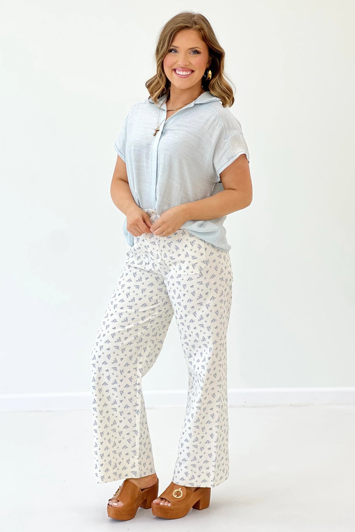Light blue short-sleeve button-down collared top, side view