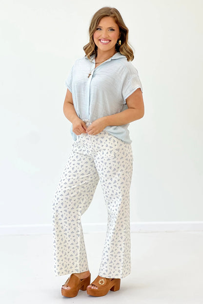 Light blue short-sleeve button-down collared top, side view