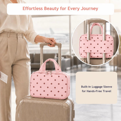 Pink polka dot makeup bag secured to a suitcase handle with its built-in luggage sleeve