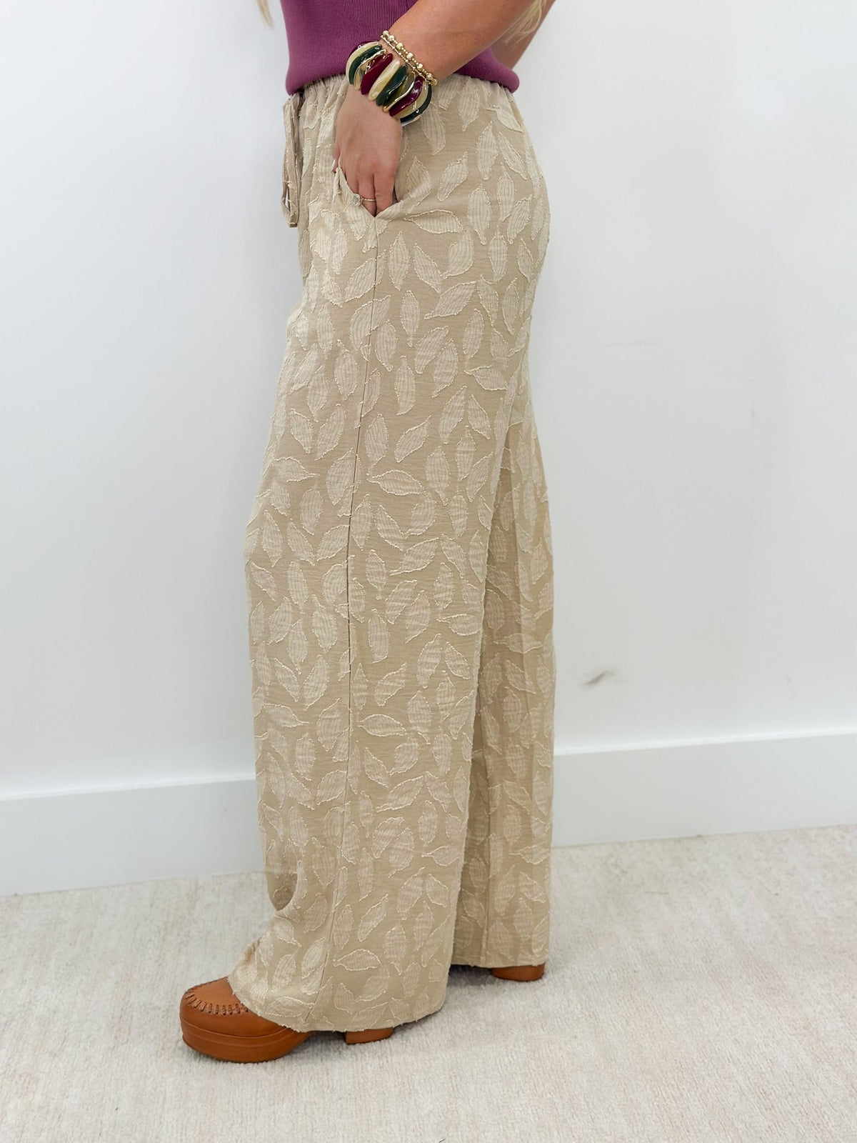 Soft taupe pants with an elasticated waist and tie belt