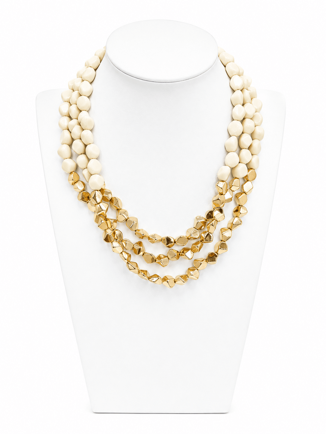 Angled acrylic pieces layered on a gold-tone chain