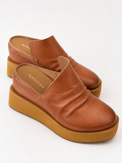 Tan platform mule with a soft ruched vamp