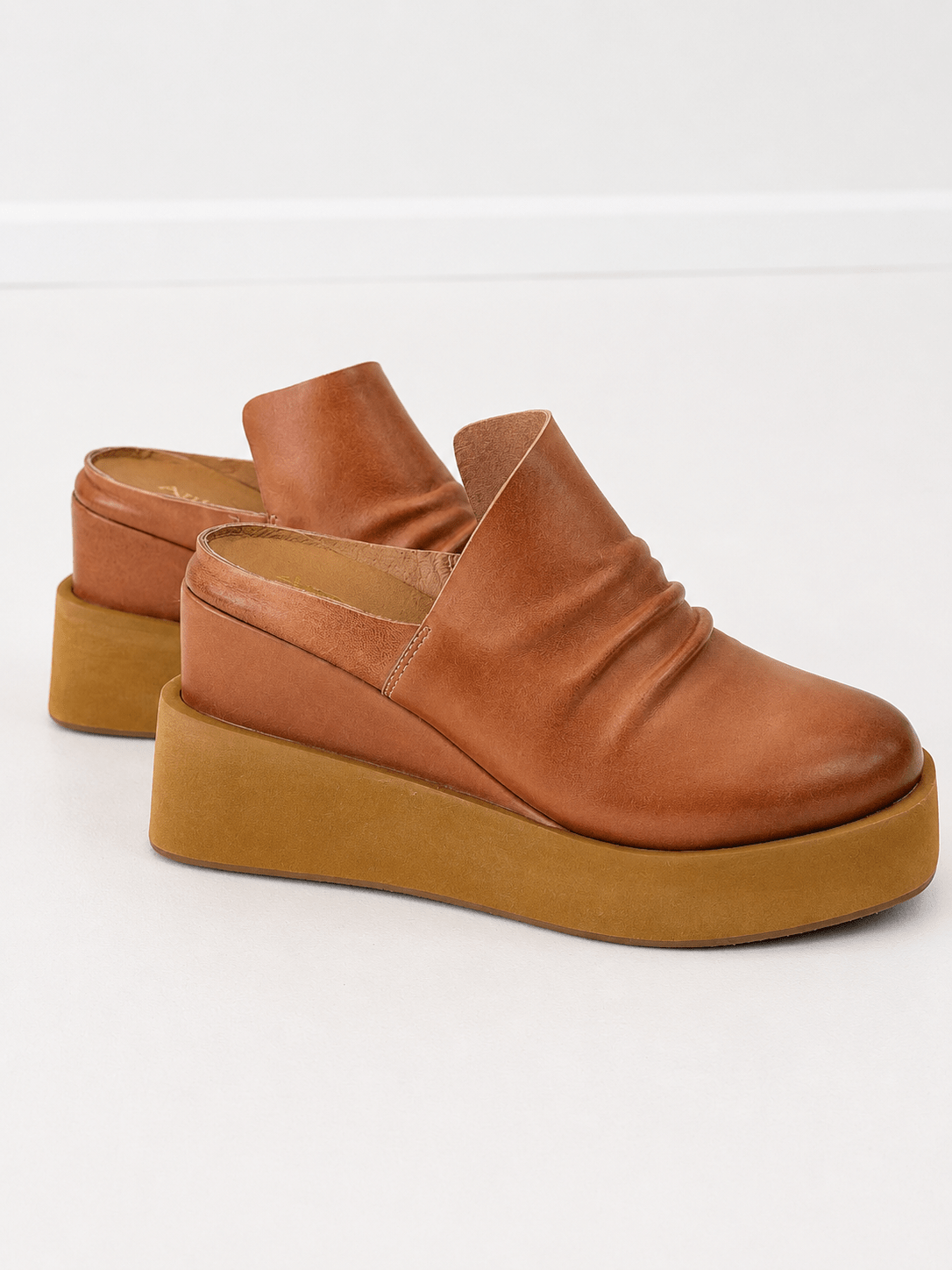 Tan leather mule with ruching across the toe and an open back