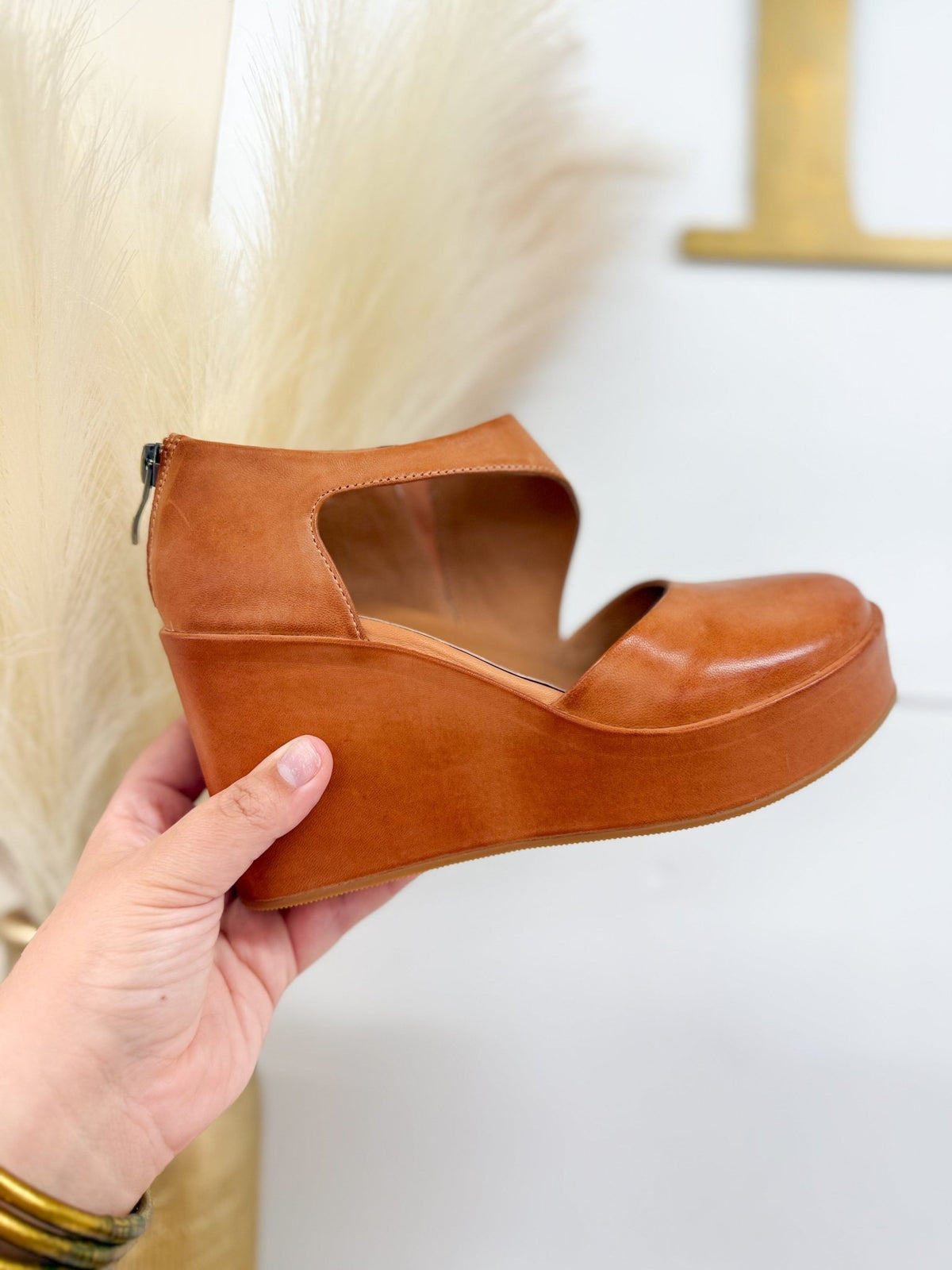 Platform wedge in taupe leather with an open cut out upper