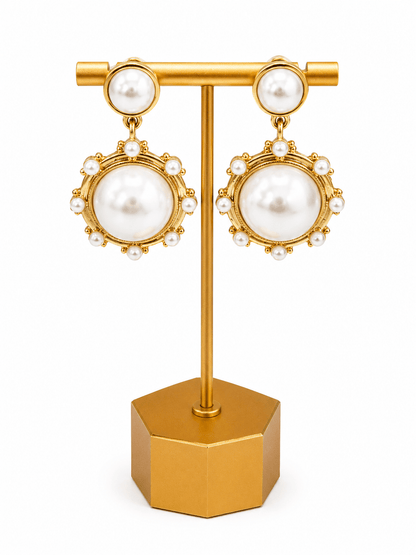 Cream pearl drop earrings with an antique gold finish