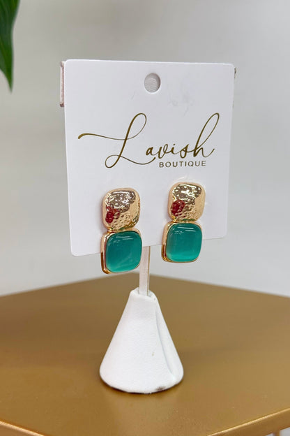 Gold earrings with a glossy aqua cat eye stone