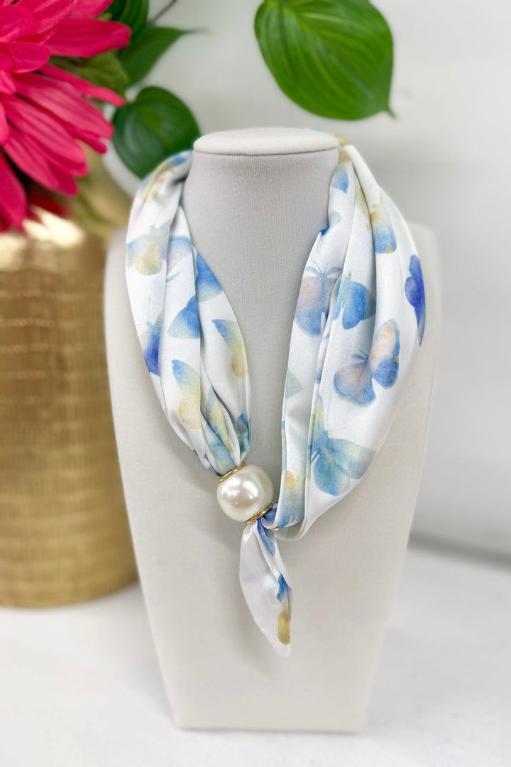 Long scarf necklace with a floral print and butterfly charm