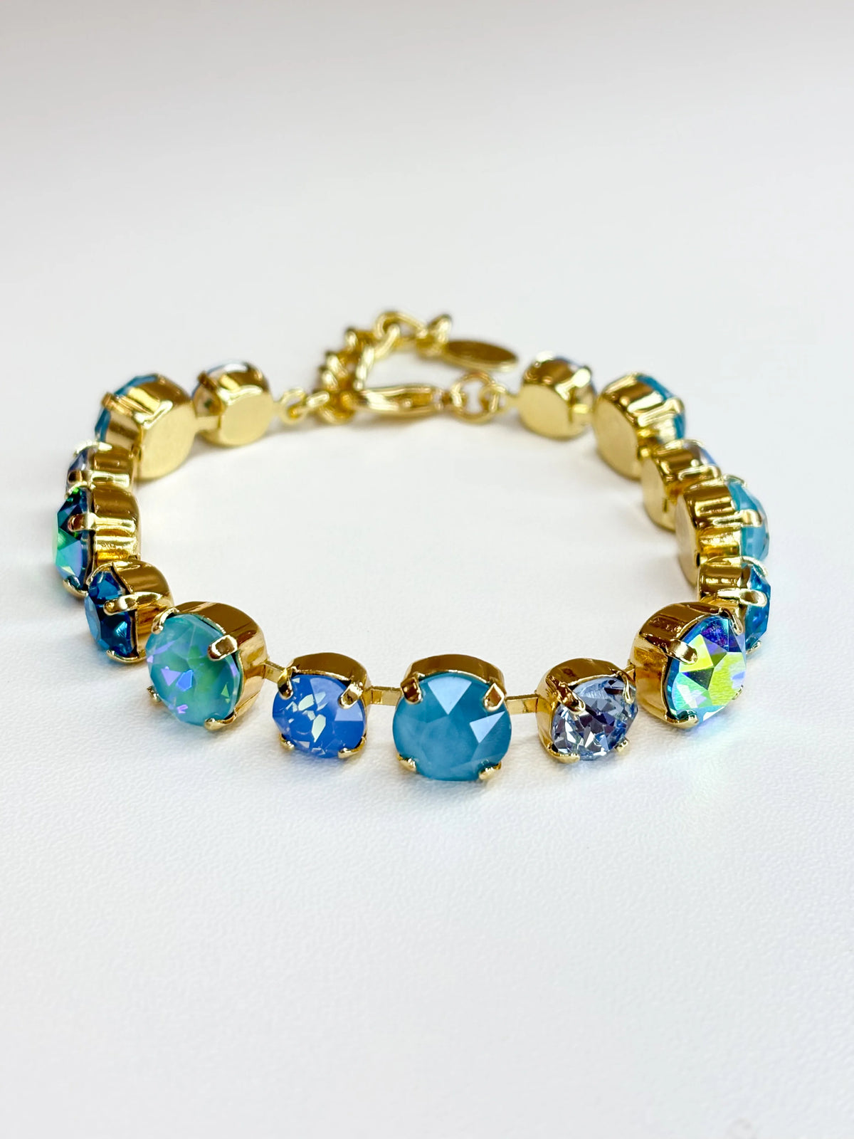 Gold-tone bracelet with blue multi crystal gemstone beads in a row
